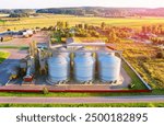 Grain storage Silo at farm, drone view. Wheat flour mill. Elevator for corn storage and grain. Feed Silos Hopper for wheat storage, barley. Wheat flour plant. Grain drying in Steel Silo, aerial view. 