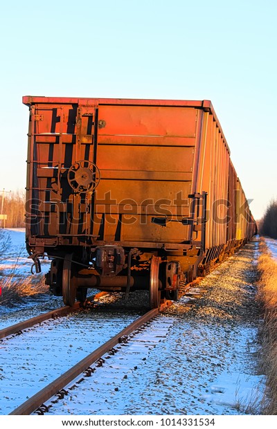 A grain train car\
waiting on a track