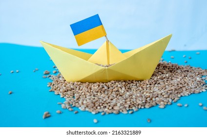 grain wheat and spikelets on a blue background. Ukrainian grain and problems of blockade of ports. - Shutterstock ID 2163321889