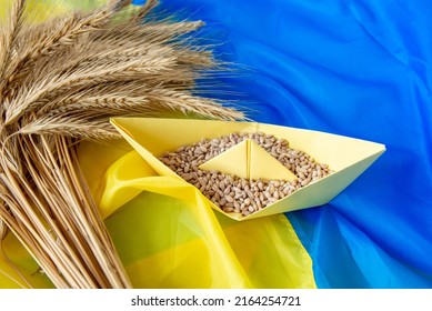 grain wheat and spikelets on a blue background. Ukrainian grain and problems of blockade of ports - Shutterstock ID 2164254721