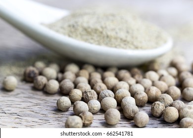 Grain White Pepper And White Pepper Powder On Wooden Table.