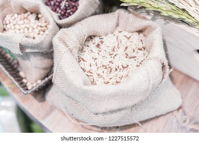 Grains, Beans, Grains And Rice In A Calico Bag On A Wooden Table. The Dried Rice Is A Component.