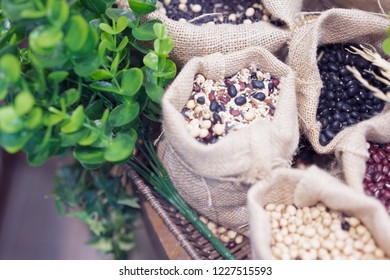 Grains, Beans, Grains And Rice In A Calico Bag On A Wooden Table. The Dried Rice Is A Component.