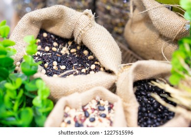 Grains, Beans, Grains And Rice In A Calico Bag On A Wooden Table. The Dried Rice Is A Component.