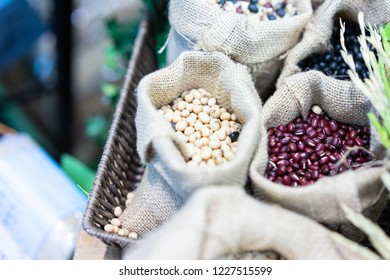 Grains, Beans, Grains And Rice In A Calico Bag On A Wooden Table. The Dried Rice Is A Component.