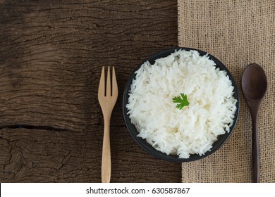 Grains Cooking Of Thai Jasmine Or White Rice In Bowl On Wooden Background