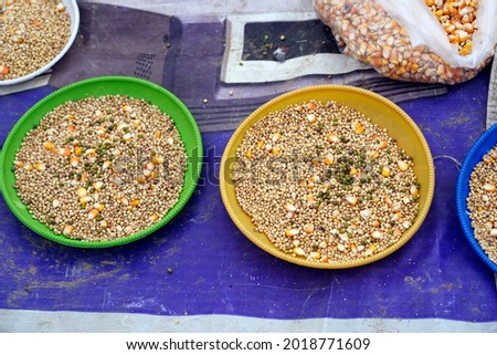 Grains and corn for bird feed kept in plates at road side