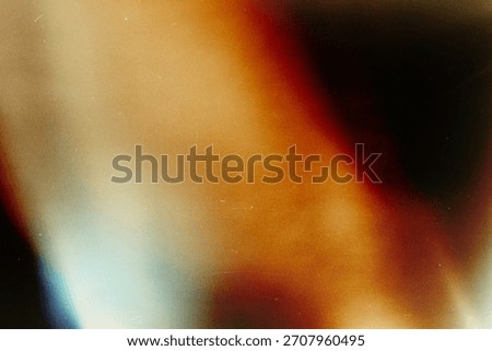 Grainy light leak texture gradient background, abstract blurred vintage effect, warm orange and blue color, retro film style, artistic mood, soft faded overlay