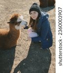 
grainy photo.funny cute woman with llama.girl with llama at the zoo.walking with llama.funny photo with animal.free range animal.rescue animals.funny photo with pet.girl and alpaca.love of animals.