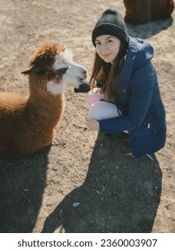 
				grainy photo.funny cute woman with llama.girl with llama at the zoo.walking with llama.funny photo with animal.free range animal.rescue animals.funny photo with pet.girl and alpaca.love of animals.