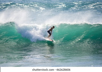 GRAN CANARIA, CANARY ISLANDS - JANUARY 05, 2014: Unidentified man surfing on a large wave on Playa del Ingles on the coast of Atlantic ocean, Gran Canaria, Canary islands, Spain