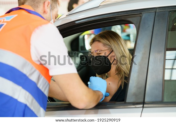 GRANADA,\
ANDALUSIA, SPAIN. FEBRUARY 26TH, 2021. Mass vaccination against\
Covid-19 of teachers and education personnel, using Astrazeneca\'s\
vaccine. Middle-aged woman getting\
vaccinated