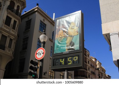 GRANADA, ANDALUSIA, SPAIN - JULY 29, 2017: City billboard with a digital thermometer displaying 45 celsius degree at the intersection of Calle Reyes Catolicos and Calle Padre Suarez streets.