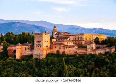 Granada, Spain. Aerial view of Alhambra Palace in Granada, Spain with Sierra Nevada mountains at the background. Sunset sky