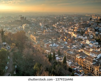 GRANADA, SPAIN - DECEMBER 27, 2018: Panoramic view of the sunset at the Granada's downtown from the Alhambra viewpoint. Granda, Spain.
