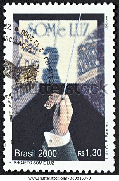 GRANADA, SPAIN -\
NOVEMBER 30, 2015: A stamp printed in Brazil shows conductor\'s hand\
with baton, 2000