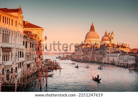 Grand Canal and Basilica Santa Maria della Salute in Venice, Italy. Beautifil cityscape at sunset. Famous tourist destination. 