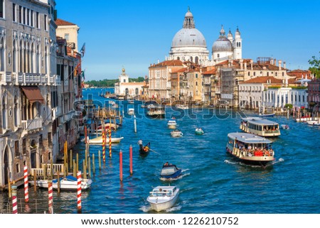Grand Canal in Venice, Italy. It is one of the main tourist attractions of Venice. Beautiful panorama of the major street of Venice with traffic. Romantic water trip across sunny Venice in summer.