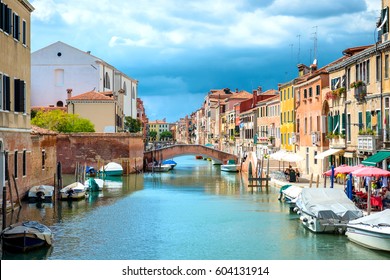 Grand Canal And Venice Streets With People In Cafe.