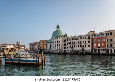 Grand Canal,Venice,Italy.Typical boat transportation.View of vaporetto station,Venetian public waterbus.Water transport.Travel urban scene.Popular tourist destination.Old houses, church along canal 