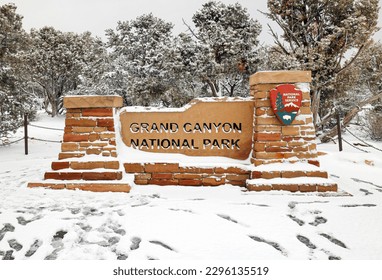 Grand Canyon National Park sign in winter surround by snow in Grand Canyon National Park, Arizona - Powered by Shutterstock