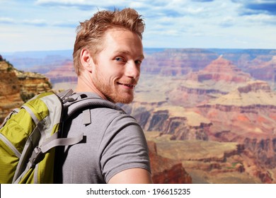Grand Canyon travel  - Successful man mountain hiker with backpack on the top of mountains. caucasian