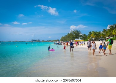 Grand Cayman, Cayman Islands, June 2021, People On Seven Mile Beach By The Caribbean Sea During A Swimming Competition 