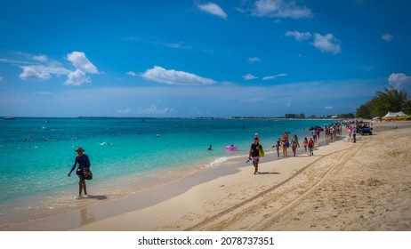 Grand Cayman, Cayman Islands, June 2021, People On Seven Mile Beach By The Caribbean Sea During A Swimming Competition 