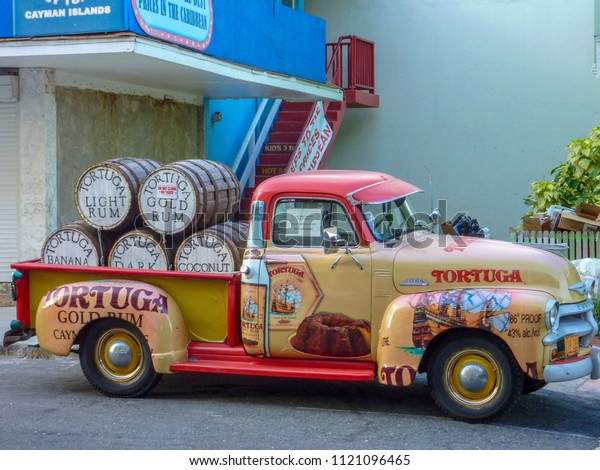 Grand Cayman\
/ Cayman Islands - May 20 2011: Antique 1951 Chevy truck loaded\
with Tortuga Gold Rum on Grand\
Cayman