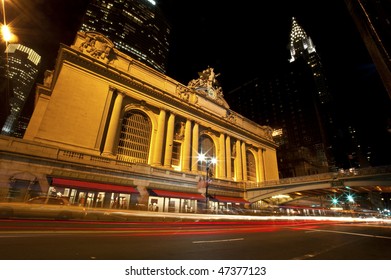 Grand Central Station Lit Up At Night, With Blurs Of Passing Cars.