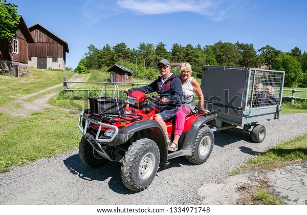 Grand dad and grand mom riding for the grandchild in\
the case to make them safe for a tour in Sweden Island on 28 August\
2017