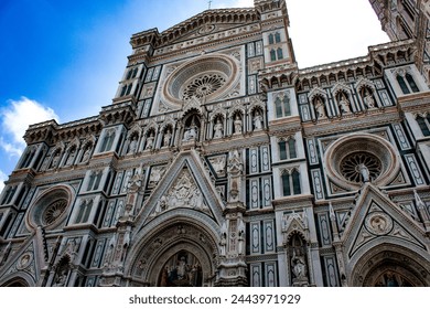The grand entrance of the Florence Cathedral captivates with its intricate marble work and majestic rose window, a breathtaking example of Gothic and Renaissance fusion. - Powered by Shutterstock
