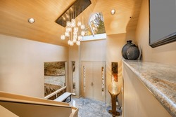 Grand Entry Foyer Of A Luxury Home With Multi Glass Ball Chandelier Granite Ledge Skylight And Large Window And Stairs