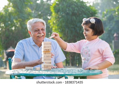 Grand Father And Grand Daughter Play Stacking Tower Skill Game