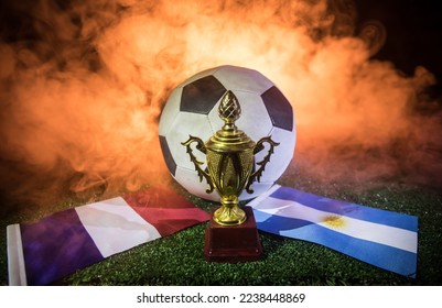 Grand Final Argentina vs France theme. Soccer ball on green grass. Support your country or cheer concept. Selective focus - Shutterstock ID 2238448869