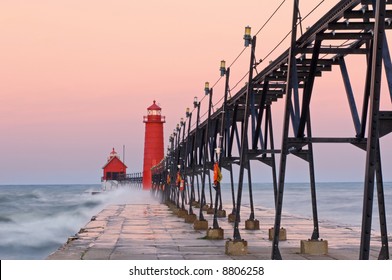Grand Haven, Michigan Lighthouse at dawn with splashing waves, Lake Michigan, USA