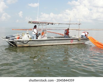 Grand Isle, Louisiana: 
June 15, 2010:
A Boat Drops Containment Booms In The Gulf Of Mexico After The Deepwater Horizon Oil Spill