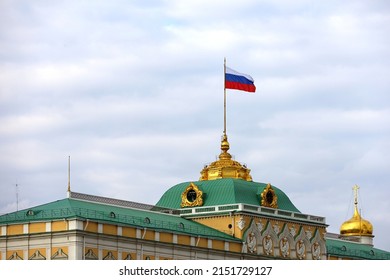 Grand Kremlin Palace With Russian Flag On Background Of Blue Sky With White Clouds