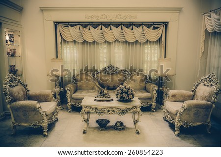 A grand living room interior architecture with various furniture in a residential house home with a luxurious and haunting retro color style. 
