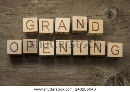 Grand Opening text on a wooden cubes on a wooden background
