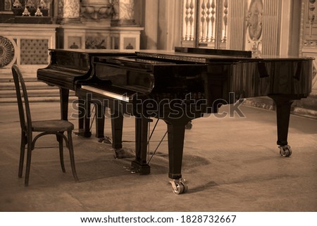 Grand piano indoors. Black and white