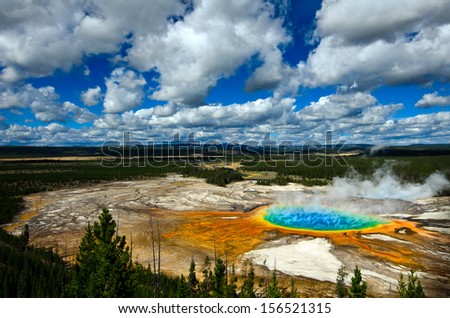 Grand Prismatic Pool at Yellowstone National Park with blue sky and puffy clouds