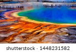 Grand Prismatice Spring in Yellowstone National Park with tourists viewing the spectacular natural scene