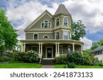 Grand Queen Anne Victorian house with turret on a beautiful early summer day in Newton, Massachusetts, USA