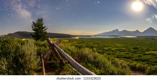 The Grand Teton Mountains, Jackson Lake, and Willow Flats by moonlight with the Milky Way Galaxy. - Powered by Shutterstock