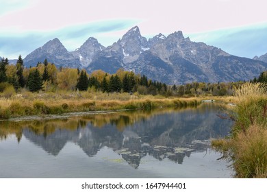 Grand Teton National Park, Wyoming., USA. Named for Grand Teton, the tallest mountain in the Teton Range. Beautiful mountains and river in early fall. Golden trees. Reflection.