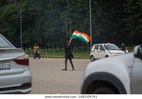 Grand Trunk Road, Punjab,
India. August 15 2019. A street vendor selling the Indian national
flag to people passing by in cars and bikes on the Indian
Independence Day. 