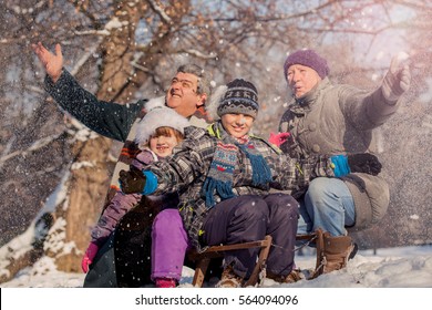 Grandchildren With Grandparents On Sleigh,winter Snowy Day