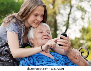 Grandchilds Help The Grandmother To Master The Smart Phone