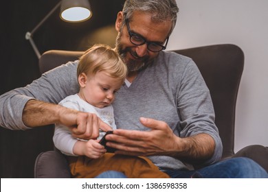 granddad and his grandson having fun at home - Shutterstock ID 1386598358